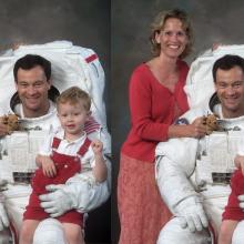 Family portrait of a man in a space suit with his wife and young son