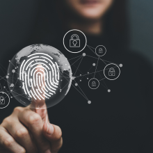 a woman holding her index finger on top of a screen with finger print illustration implying digital security
