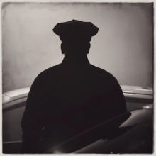 Police officer in silhouette.
