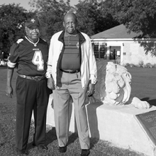 African American golfers stand on the putting green at the golf course they helped integrate.