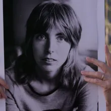 Vivien Hillgrove holding a photo of her younger self.