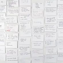 Photograph of a wall of index cards.