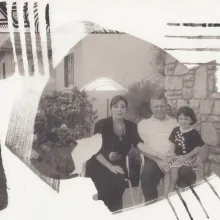 Collage-like black and white image of a man and a woman, with their young daughter in the father's lap