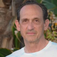 A middle aged man looking directly into the camera