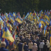 A crowd of people follows the coffin of a fallen soldier being buried at the Field of Mars military cemetery in Lviv.