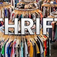 Stacks of clothes at a thrift shop