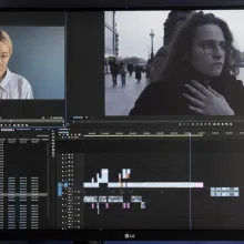 A monitor shows a film project being cut using editing software 
