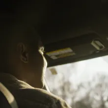 Close up of a man driving, shot from behind