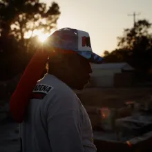 Silhouette of Altadena resident at sunset standing on the foundation of his property