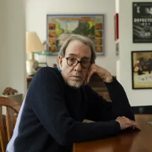 A white man sits at his dining room table.
