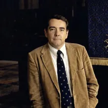 A picture of Rev. Raymond Judd Jr. in the late 1970's, standing next to the pulpit in the Trinity Chapel that he preached on for over 30 years.