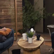 2 people sitting across from each other coffee table between them