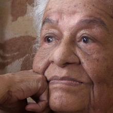 Mama Icha is a senior Colombian woman seen here wistfully lost in thought. From Oscar Molina’s ‘La Casa de Mama Icha.’ Courtesy of Oscar Molina.