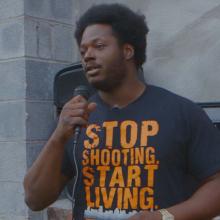 Alex Long of East Baltimore speaks at a community gathering about the need to stop gun violence. Photo courtesy of Andre Lambertson.