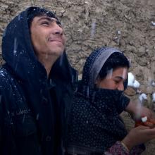 A young Afghan couple pictured in the snow. Image from Elizabeth and Gulistan Mirzaei’s ‘Three Songs for Benazir,’ which is set and filmed in refugee camps in Afghanistan. Courtesy of the filmmakers.