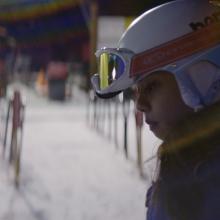 Sarah Rose Huckman, a young transgender woman in skiing gear. Ski resort behind her. She is the protagonist of ‘Changing the Game’ (Directed by Michael Barnett)