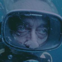 Film still of Jacques Costeau underwater in scuba diving gear. Courtesy of National Geographic
