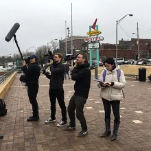 Members of the film crew—consisting of three white men and two women—of ‘Who We Are’ filming Jeffery Robinson—a Black man in a black blazer and pants—in front of Memphis’ Lorraine Motel. Photo courtesy of Sony Pictures.