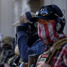 2 far-right extremists, dressed in flannel shirts, bullet-proof vests and baseball caps, outside the US Capitol on January 6.