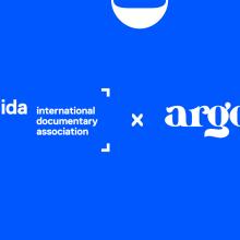 Logos of International Documentary Association (IDA) and argo against a bright blue background