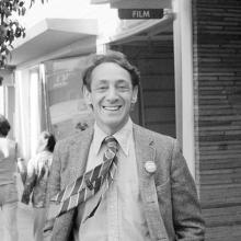 A black-and-white photo of a man smiling from Rob Epstein and Richard Schienchen’s 'The Times of Harvey Milk.'