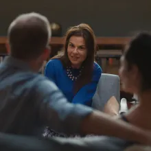 Dr. Orna Guralnik, PsyD is a white woman with dark hair sitting across from her patients in a couples therapy session. Film still from 'Couples Therapy' courtesy of Showtime.