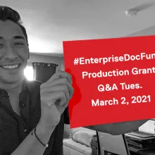 Grants Coordinator Kenny Brown, man in 20s with mixed Asian and European ancestry, holding up paper with text: "#EnterpriseDocFund Q&A Tues. March 2, 2021"