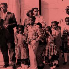 Civil rights attorney Paul Zuber being interviewed outside Roosevelt school with parents and children who were refused registration, New Rochelle, 1960.