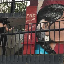 filmmaker filming mural of indigenous woman