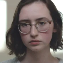 A photo of a female Caucasian with glasses.