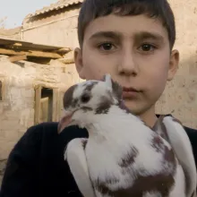 Vrej pauses with a dove days after being displaced from his hometown as a result of the 2020 war in The Republic of Artsakh. 