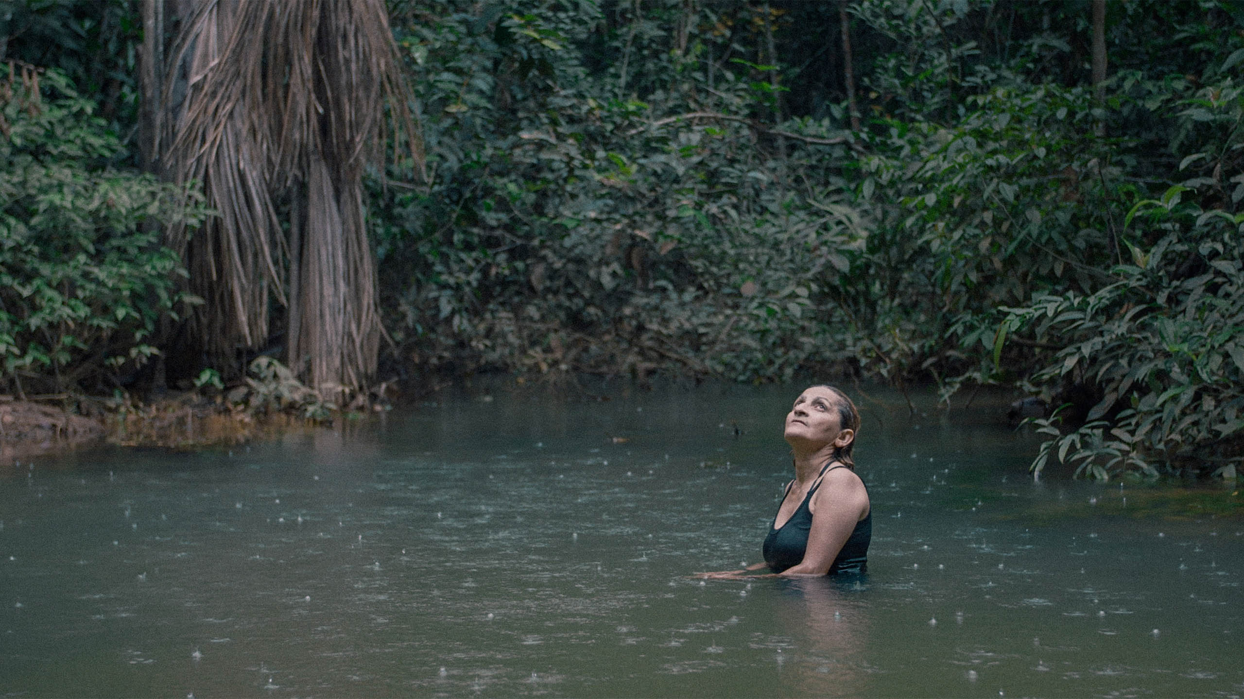  Neidinha Bandeira, an environmental activist, bathes in a river in the Amazon rainforest. From Alex Pritz’s ‘The Territory.’ Photo courtesy of National Geographic.